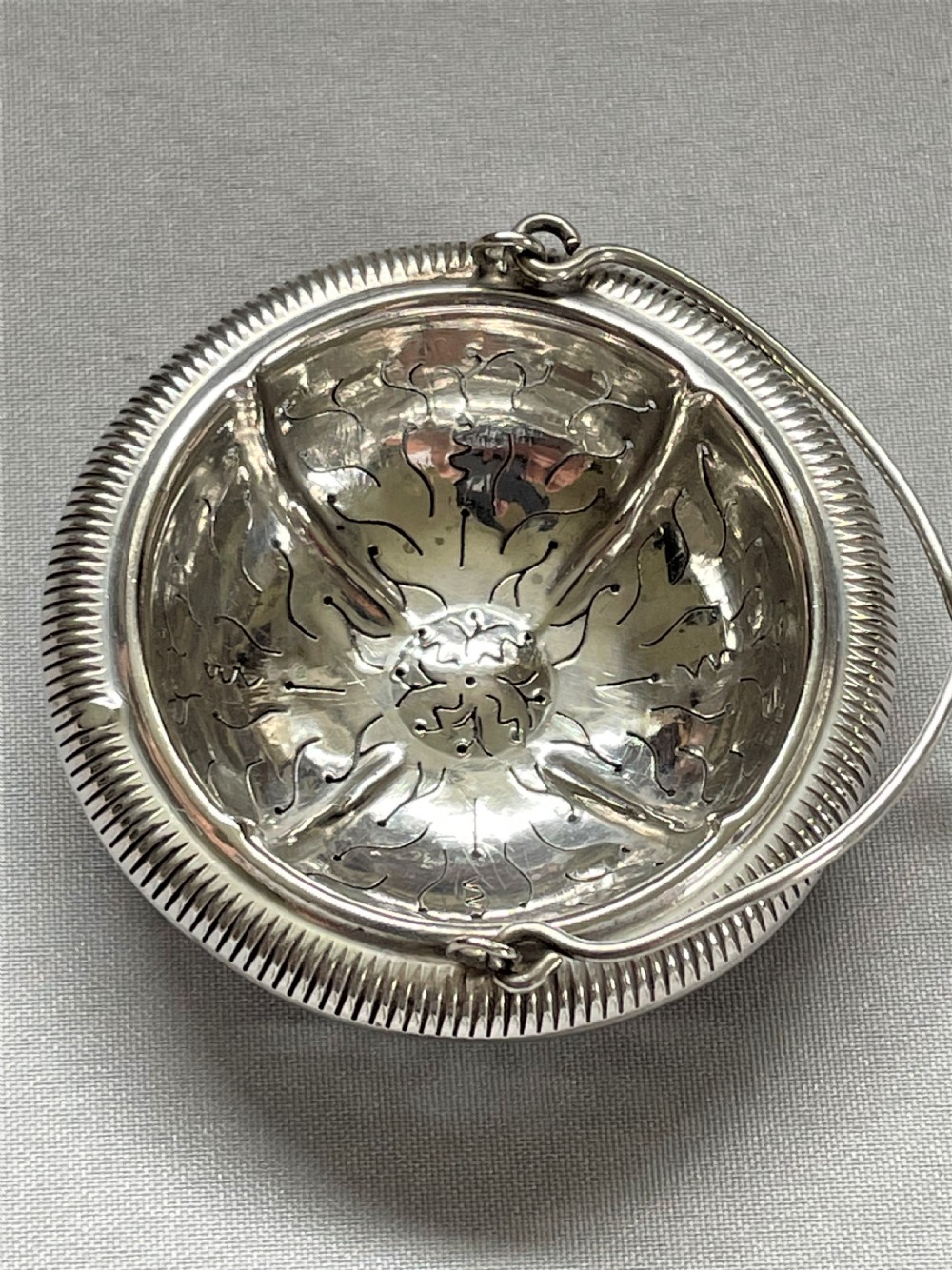 A charming French silver suspension tea strainer View VI