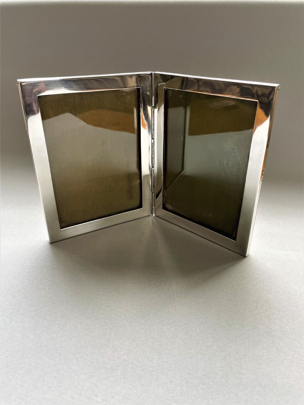 A rare silver double folding photo frame