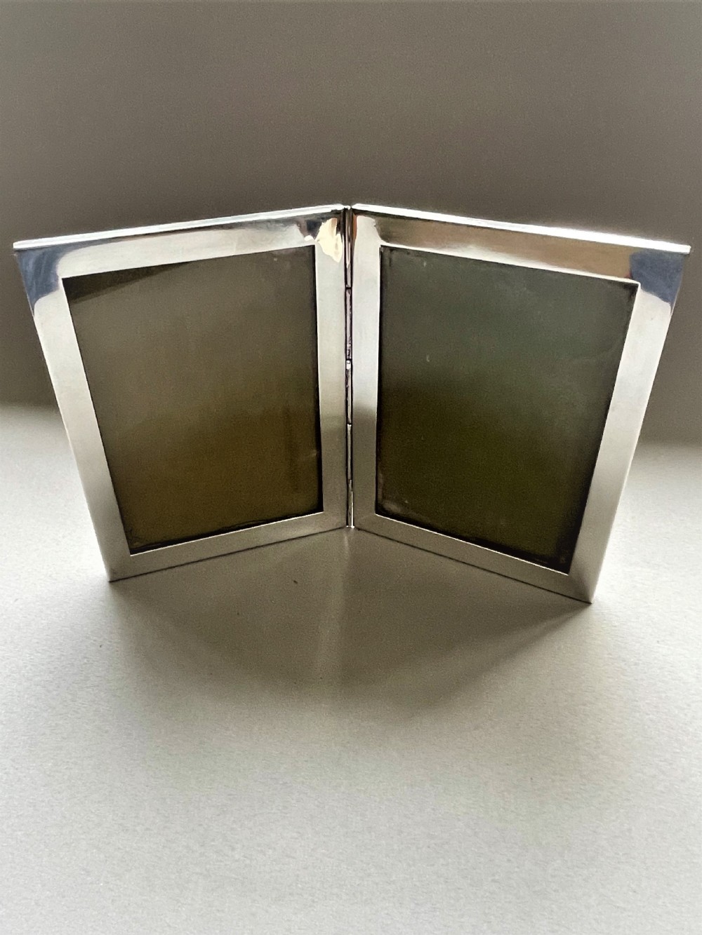 A rare silver double folding photo frame View VII
