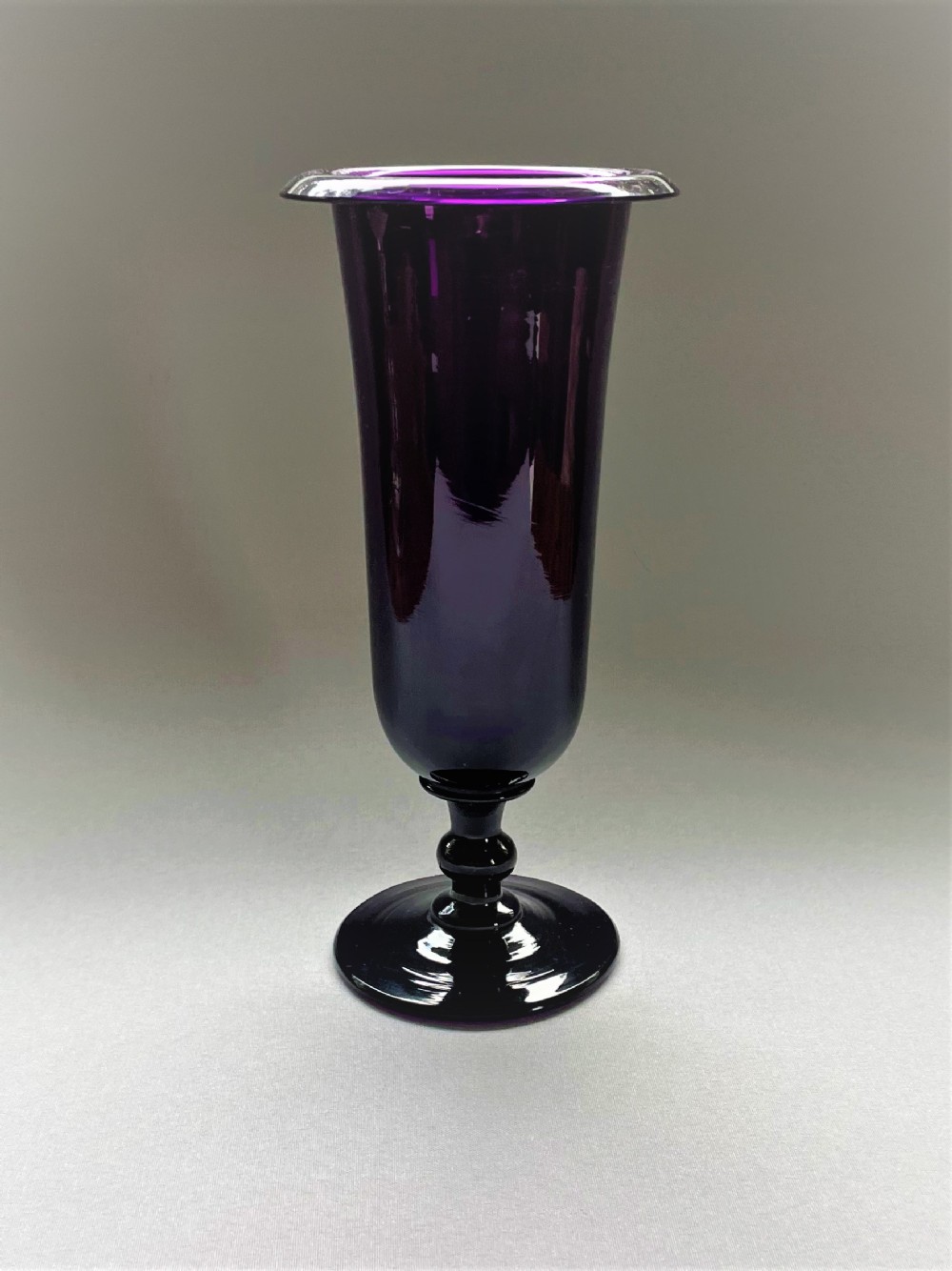 A gorgeous amethyst glass Victorian stem vase
