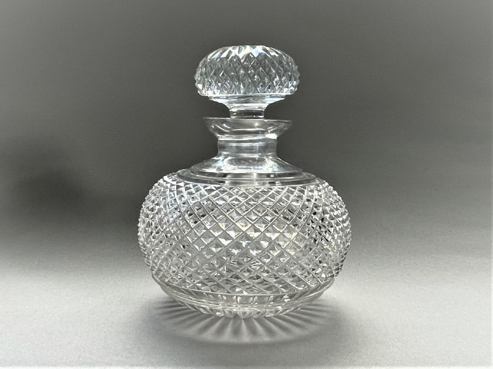 A late Victorian hobnail cut table cologne bottle