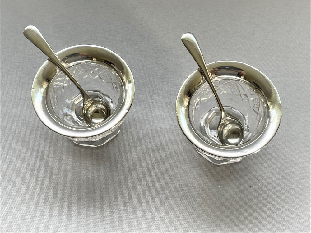 A charming silver mounted salt & pepper duo & spoons View II