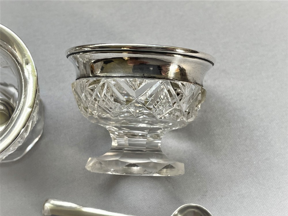 A charming silver mounted salt & pepper duo & spoons View III