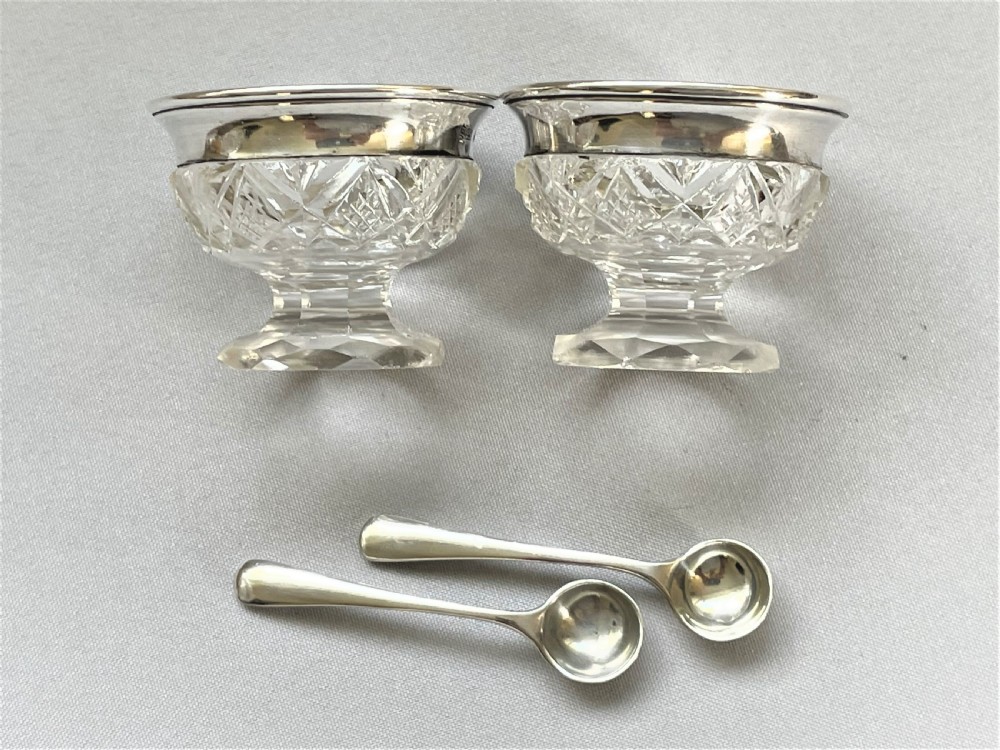 A charming silver mounted salt & pepper duo & spoons View V