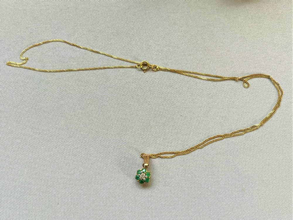 A pretty gold mounted emerald and diamond pendant View IV