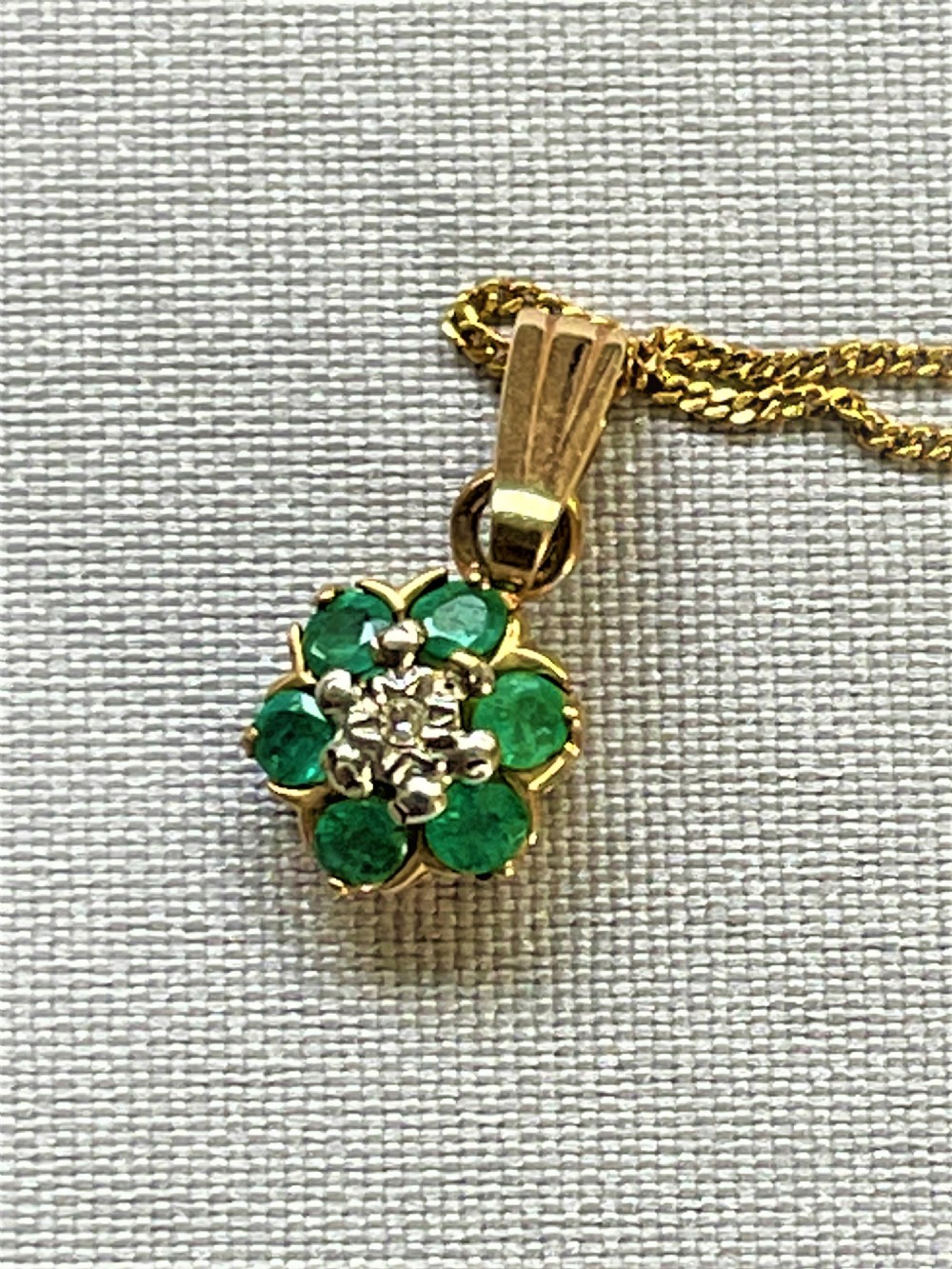 A pretty gold mounted emerald and diamond pendant View V