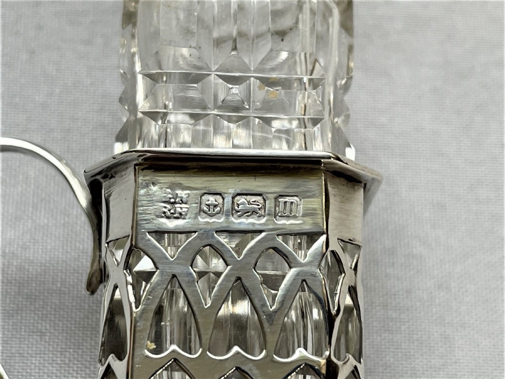 A delightful silver & cut glass Cayenne bottle and spoon View IV