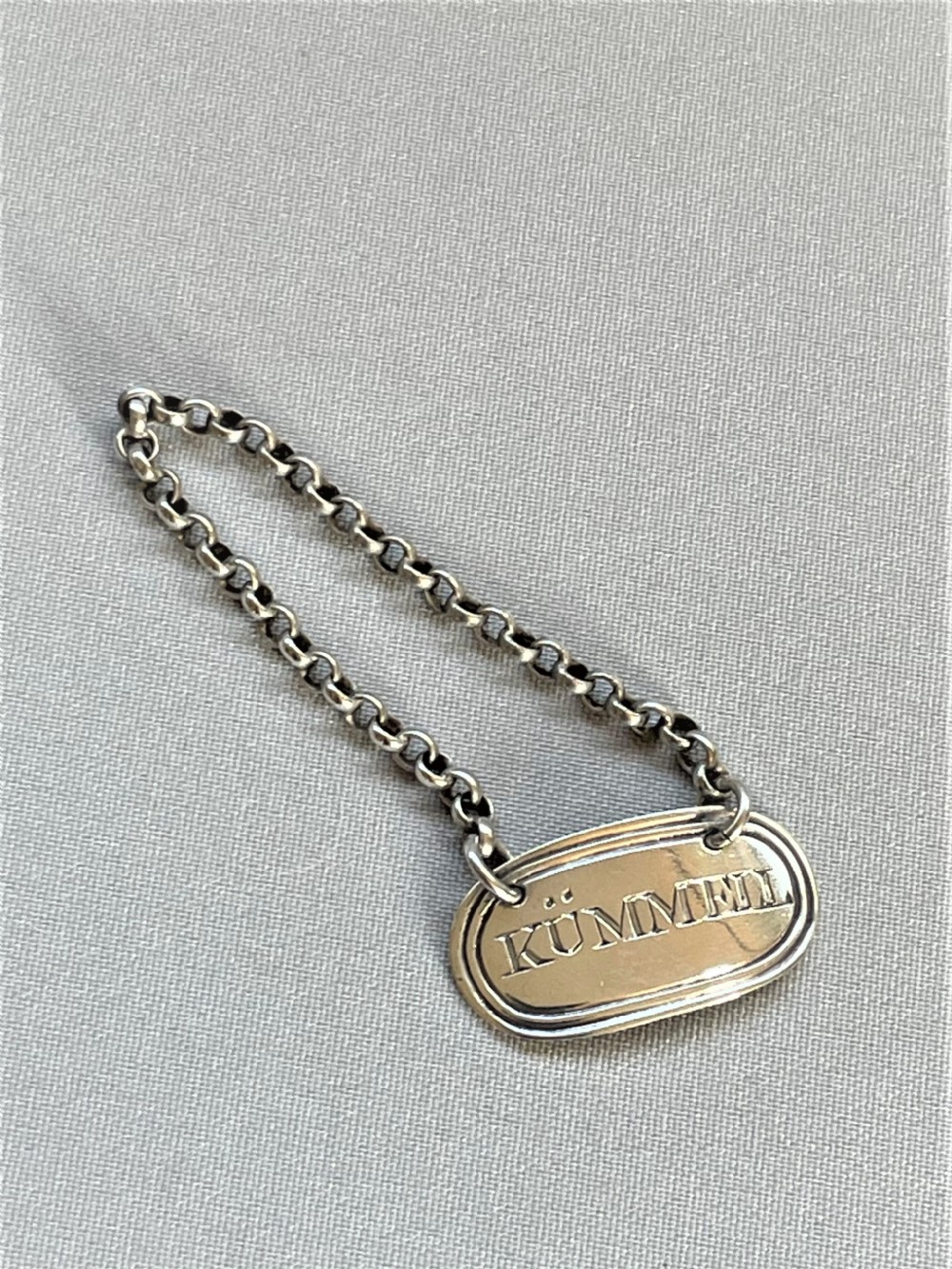 A desirable silver 'Kummell' tot label