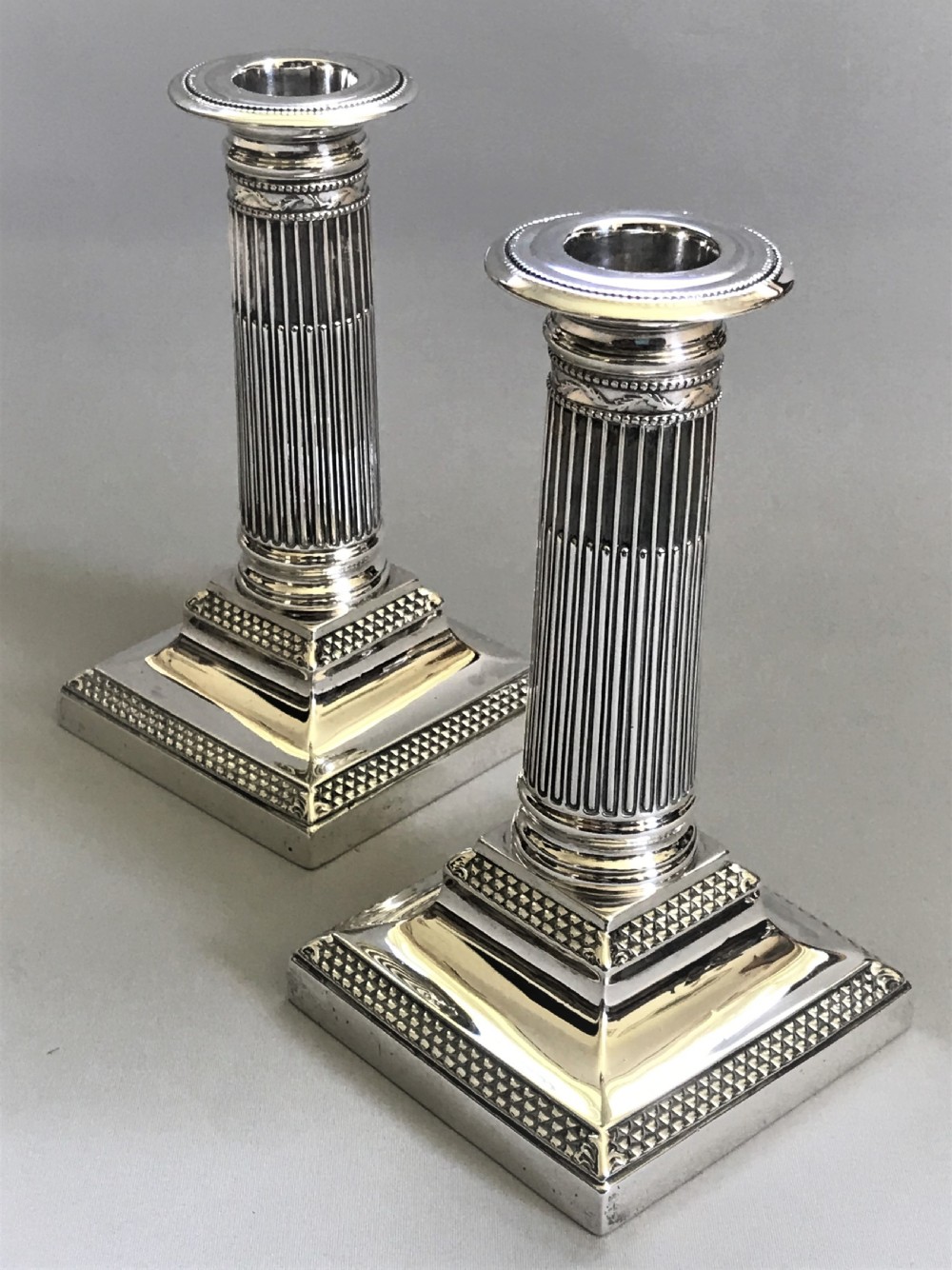 A superb pair of Victorian silver candle sticks View II