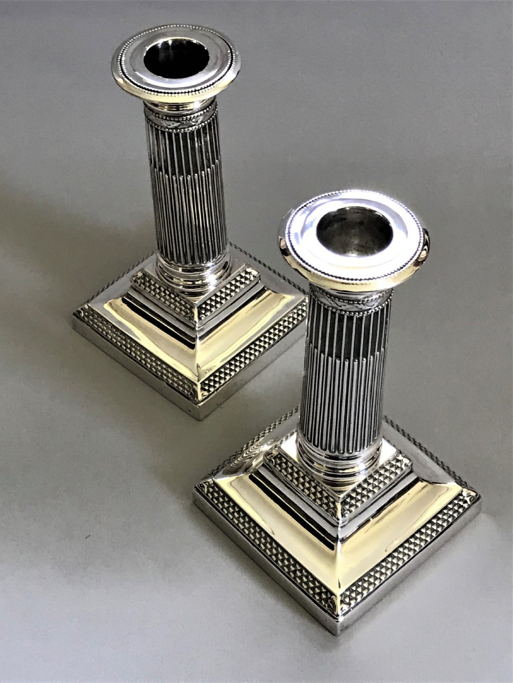 A superb pair of Victorian silver candle sticks View III