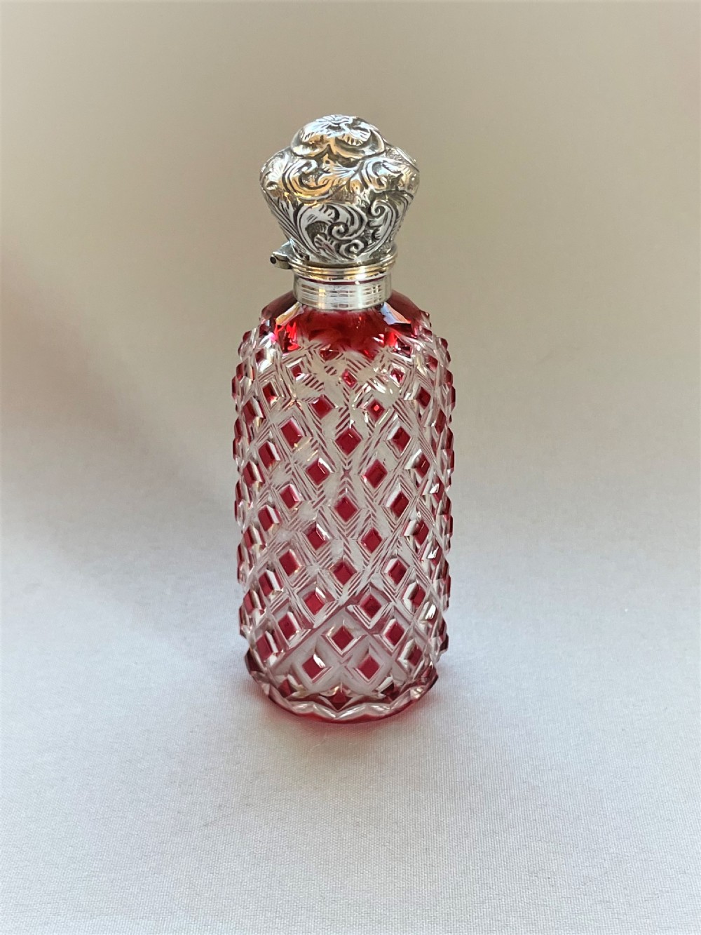 A Victorian silver mounted cranberry scent bottle