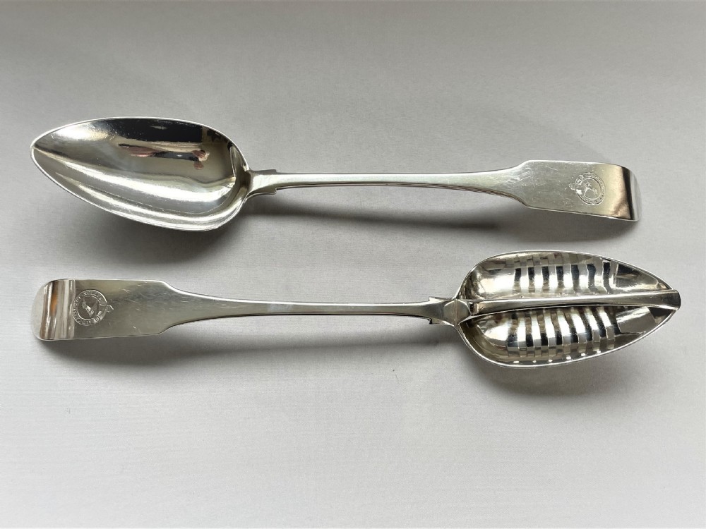 An outstanding duo of Irish Georgian silver basting/straining spoons