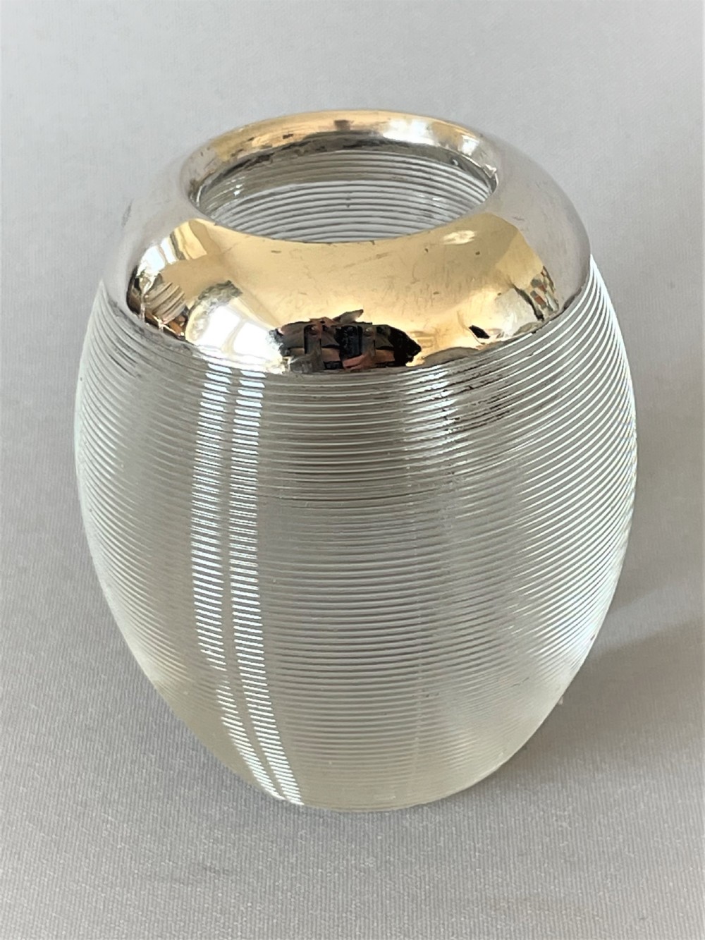An unusual oval shaped & silver mounted match striker