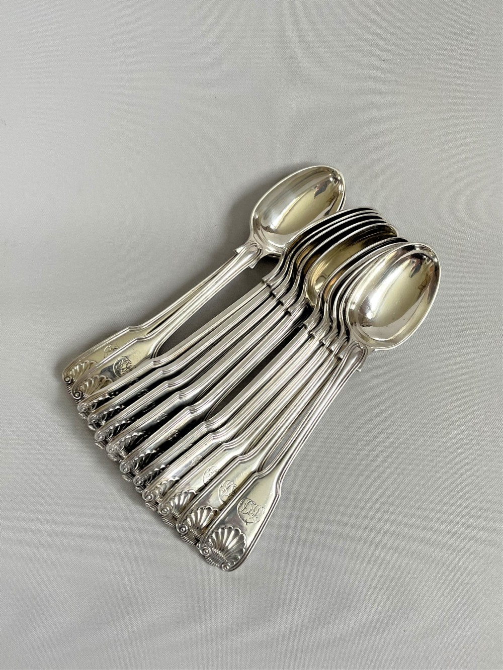 A superb set of 12 Victorian silver Fiddle, Thread & Shell teaspoons