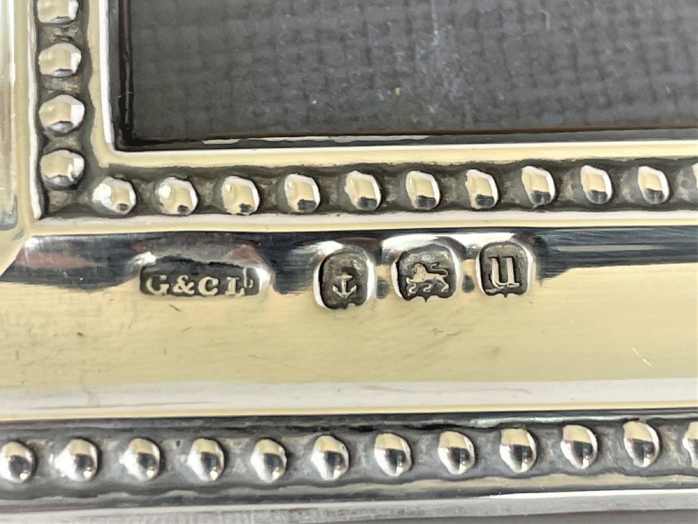 A fine George V silver photo frame with beaded edging View VII