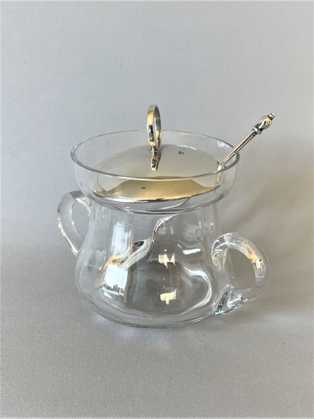 A silver mounted preserve jar with hallmarked silver spoon