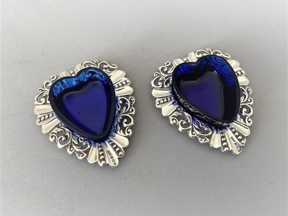A pair of Edwardian silver & glass heart shaped salt dishes View II