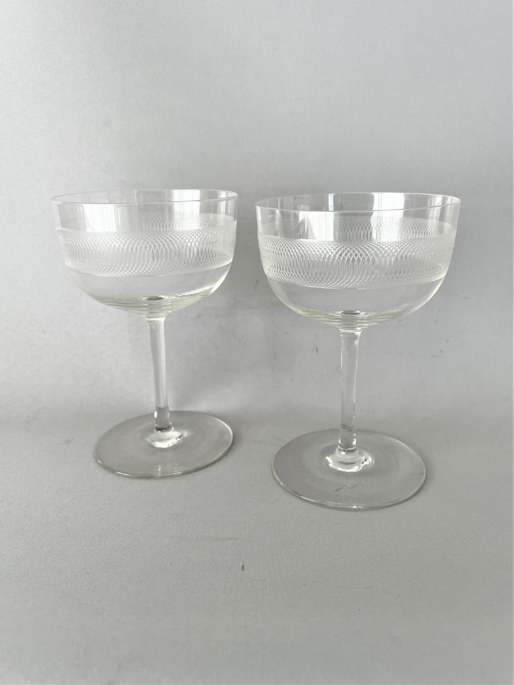 A charming pair of etched Edwardian champagne coupes