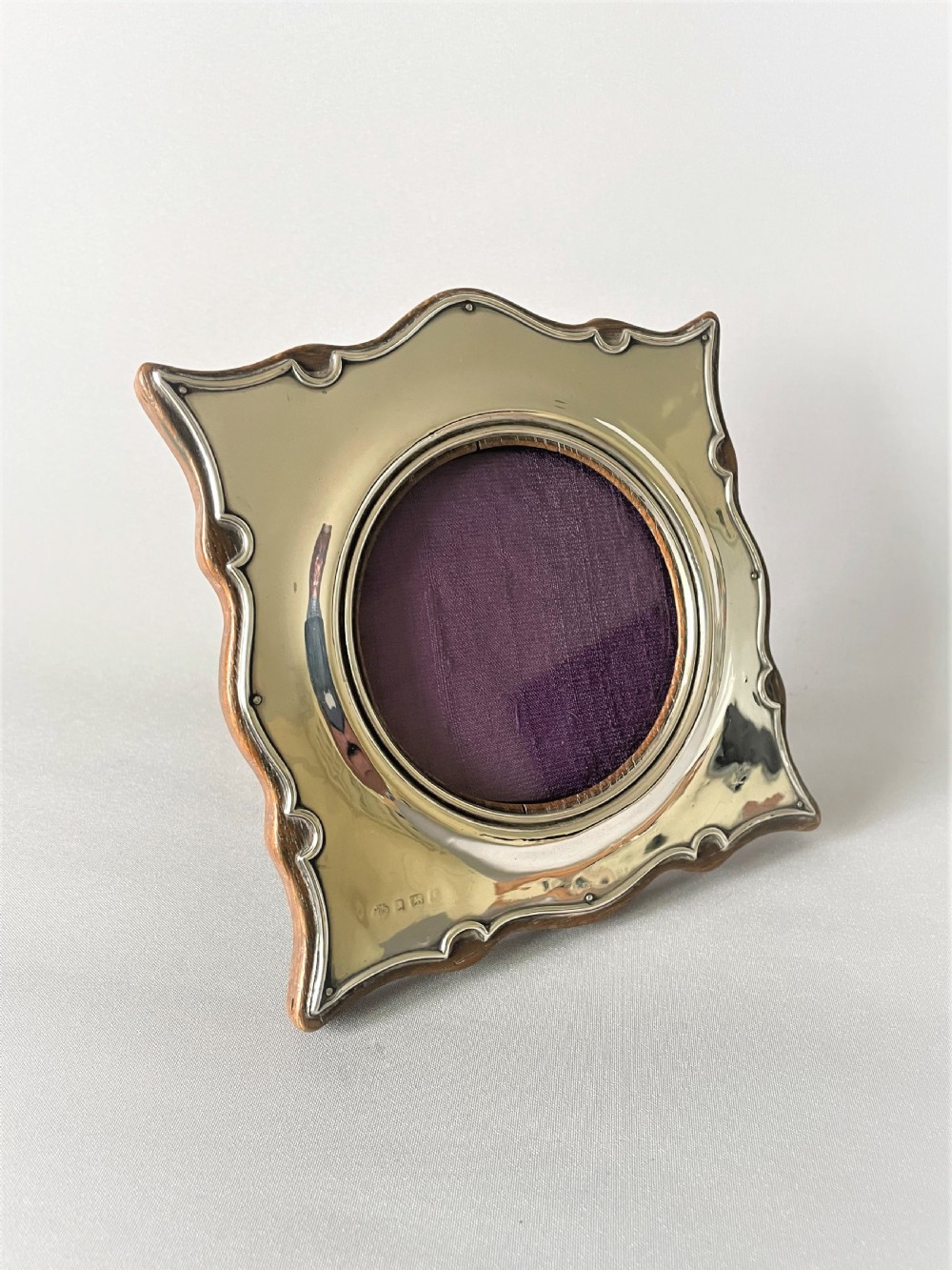 A charming shaped Edwardian silver photo frame