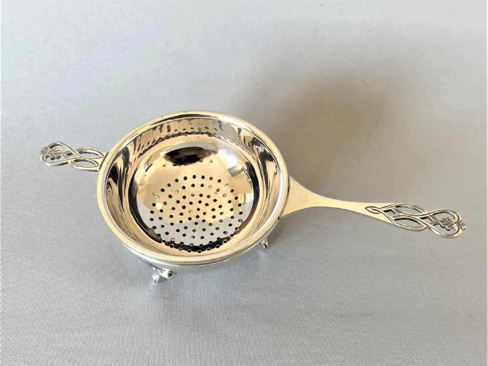 A handsome silver tea strainer & matching drip cup View II
