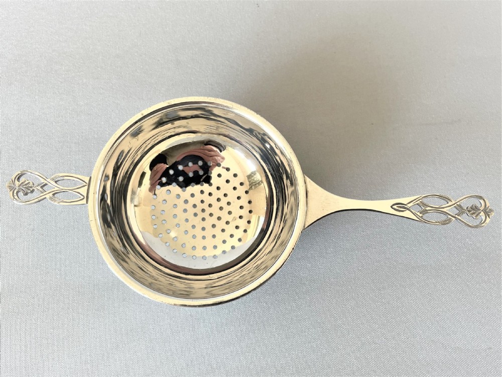A handsome silver tea strainer & matching drip cup View V