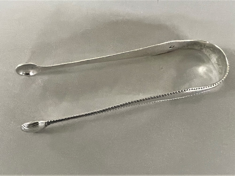 A Susannah Barker pair of 18th Century silver tongs View II