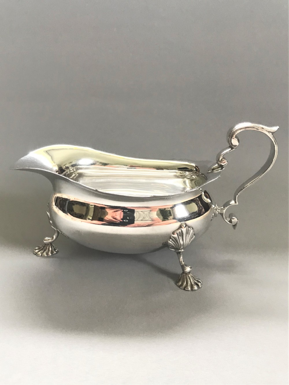 A handsome and large silver gravy boat