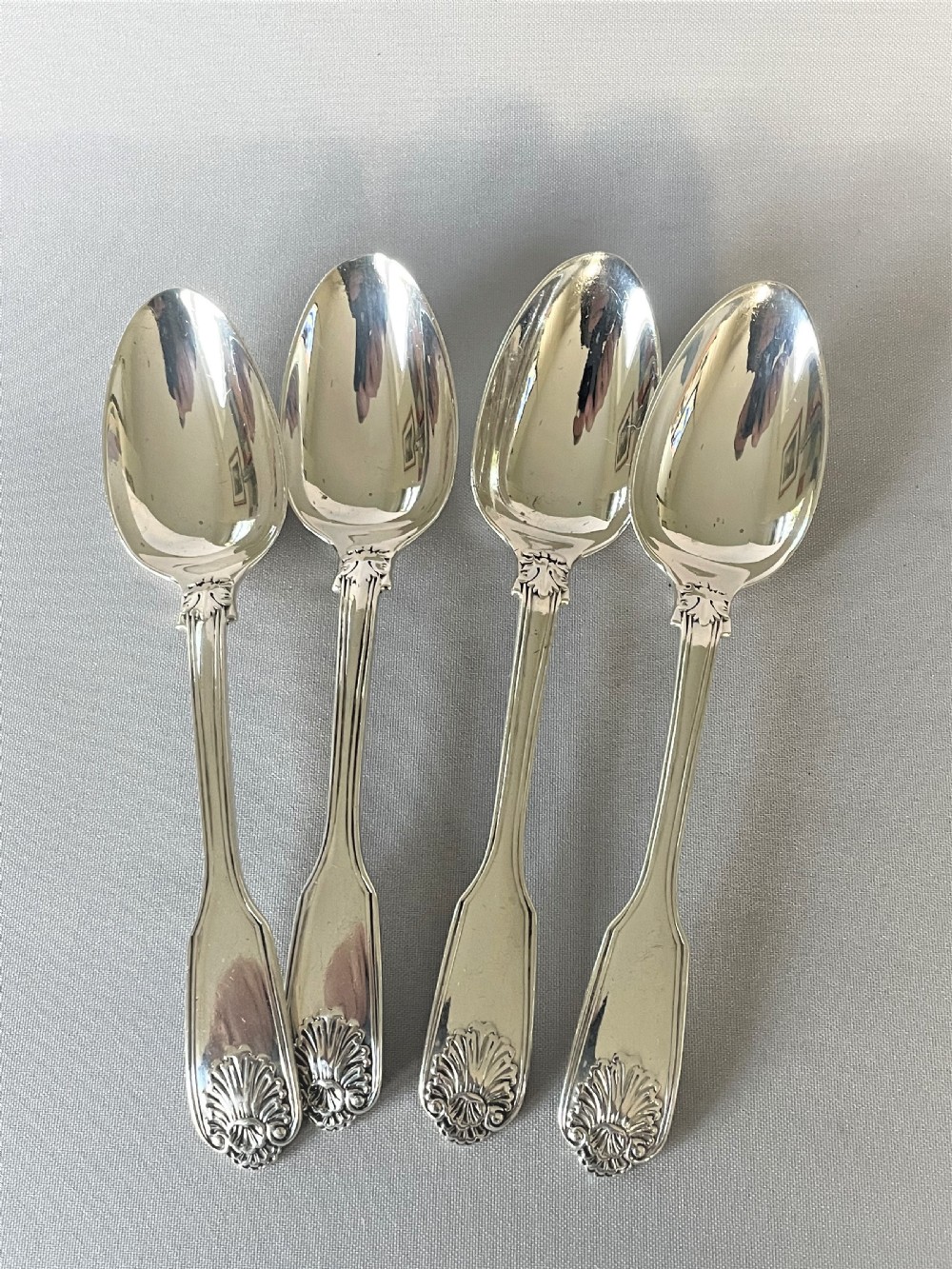 A rare set of 4 silver fiddle, thread & husk pattern teaspoons