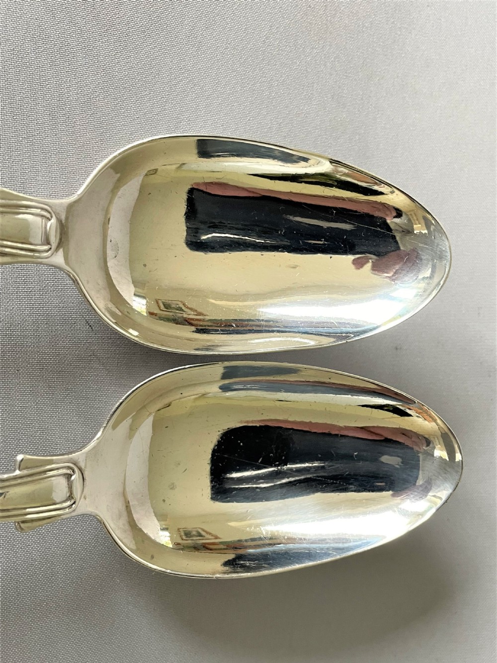 A handsome pair of Georgian silver fiddle, thread & shell table spoons View III