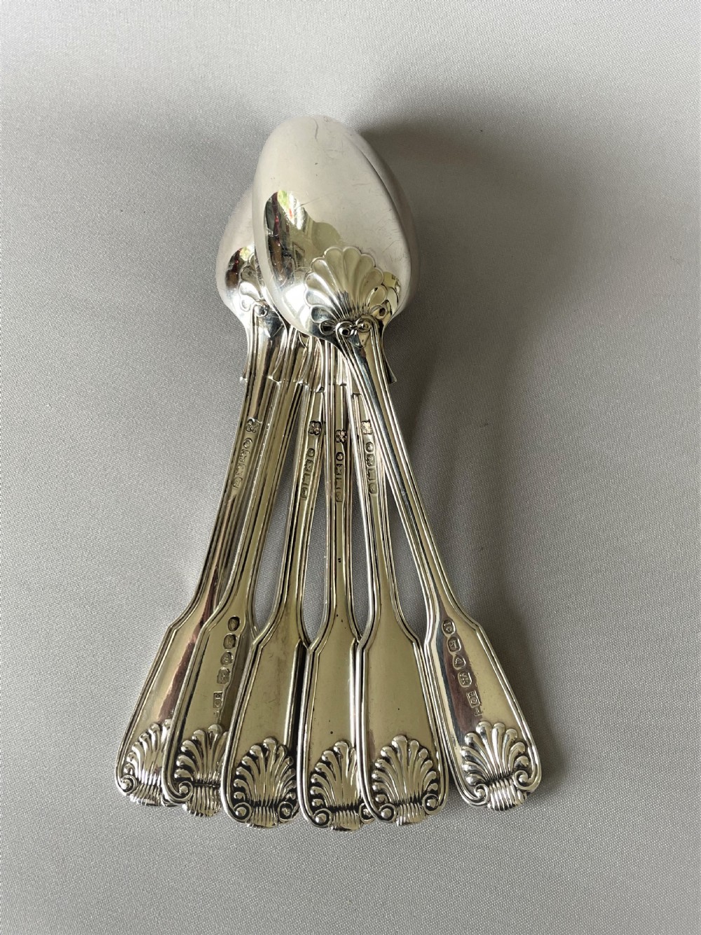 A superb matched set of silver Fiddle, thread & shell dessert spoons View V