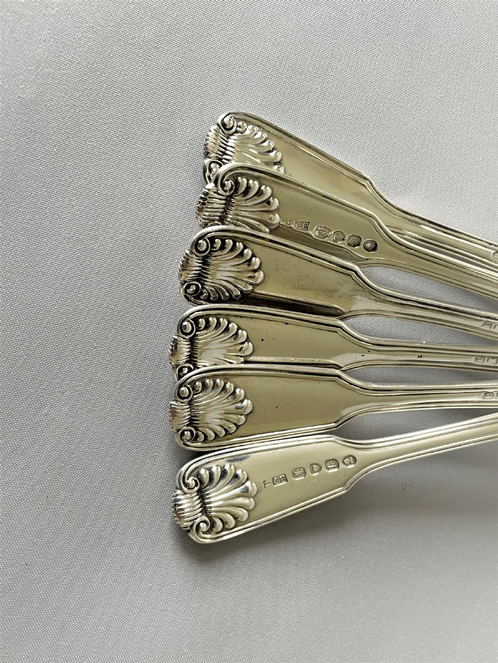 A superb matched set of silver Fiddle, thread & shell dessert spoons View VI