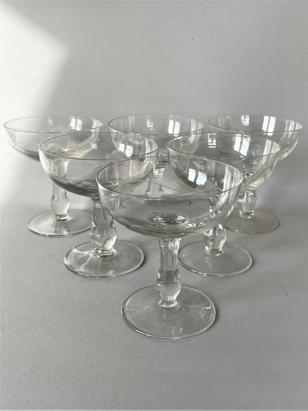 A set of six vintage etched champagne coupes