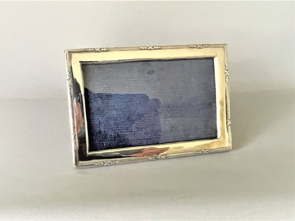 A charming small silver landscape/portrait photo frame