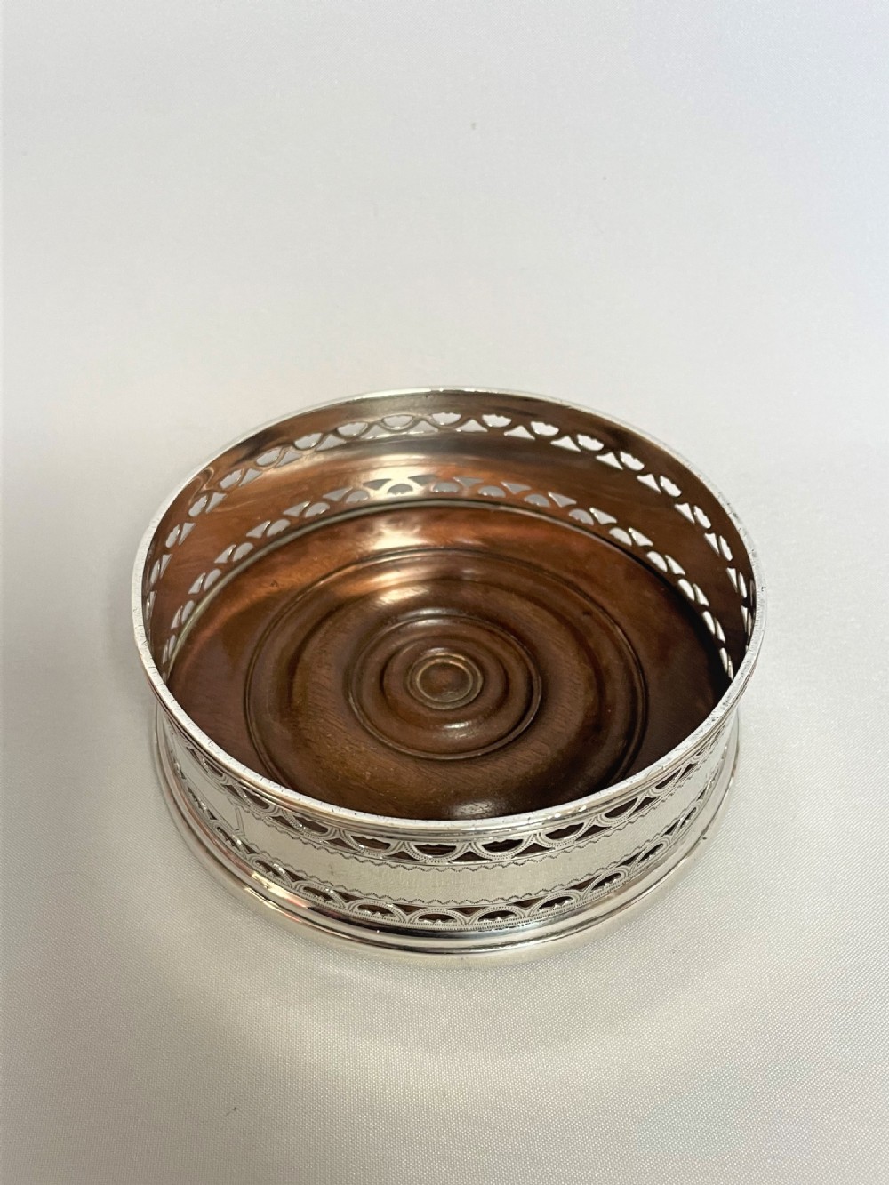 A hallmarked silver wine bottle/decanter coaster