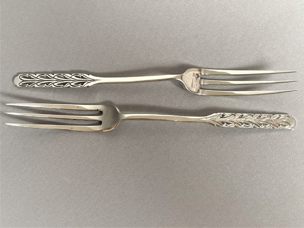 A rare pair of Liberty & Co. silver pickle/sweetmeat forks