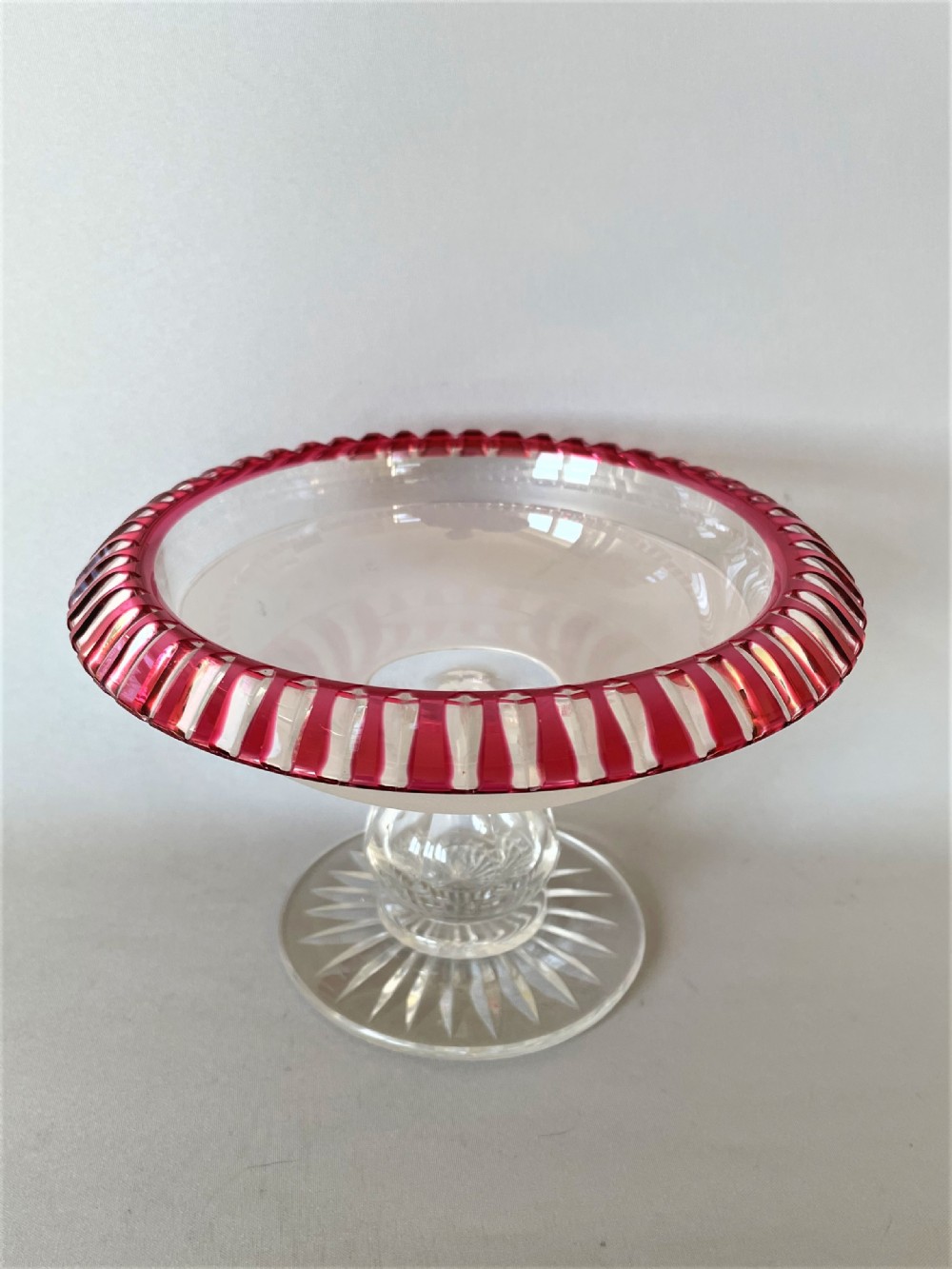 A Victorian cranberry edged cut glass comport