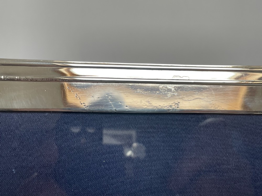 A large silver photo frame with unusual silver mount View III
