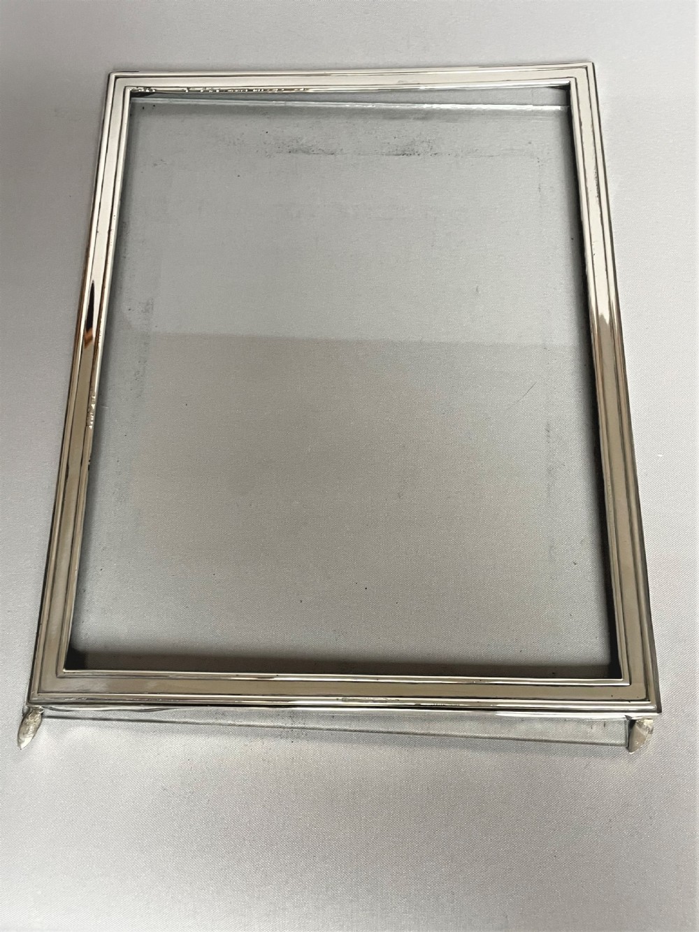 A large silver photo frame with unusual silver mount View VI