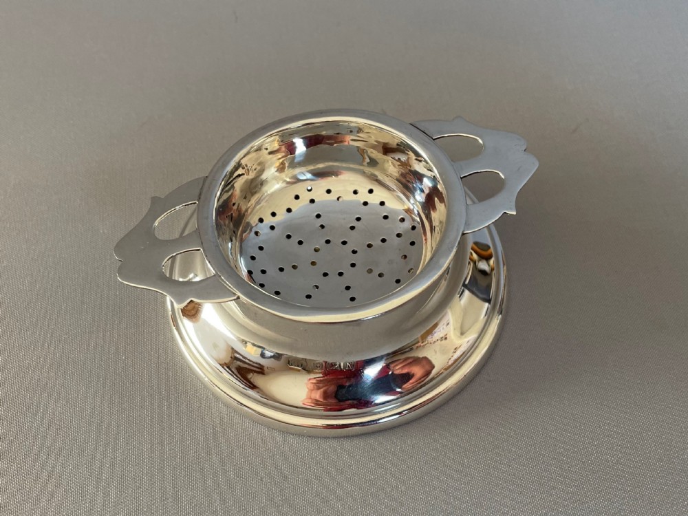 A fine hallmarked silver tea strainer & drip cup View II