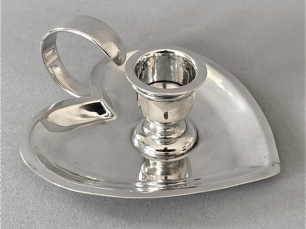 A lovely Chester silver heart shaped chamber stick
