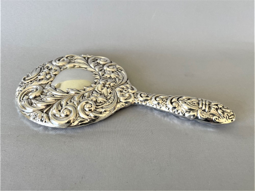 A gorgeous vintage silver hand mirror View II