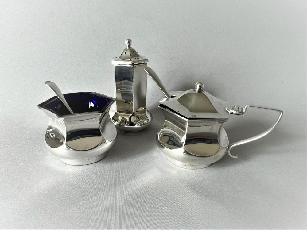 A Stylish Art Deco Three Piece Silver Cruet & Spoons