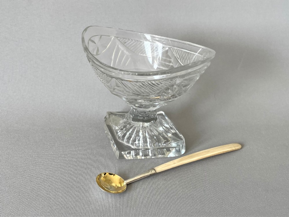  A superb Georgian cut glass boat salt with period silver gilt spoon