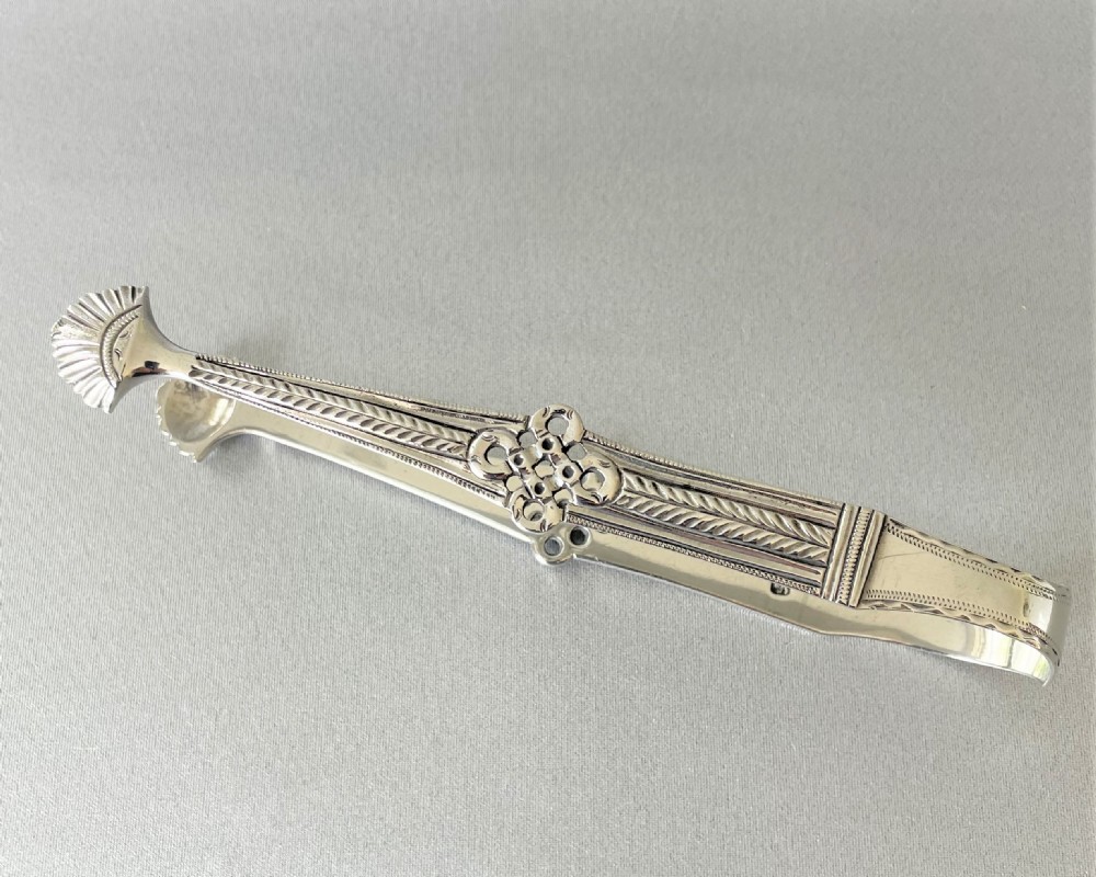 A superb cast pair of 18th Century silver tongs