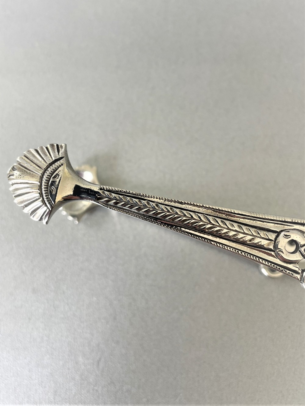 A superb cast pair of 18th Century silver tongs View II
