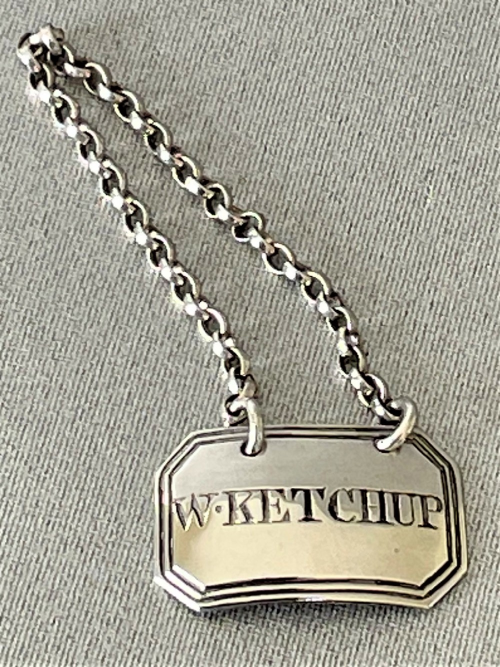 An extremely rare Walnut Ketchup Georgian silver bottle ticket