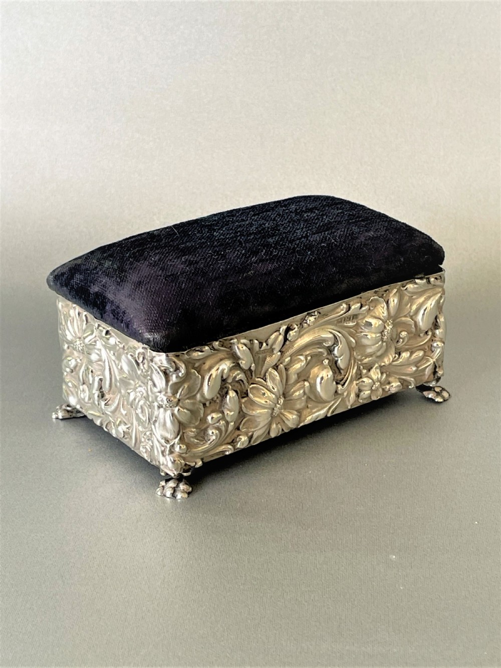 A lovely silver cased trinket box with pin cushion lid