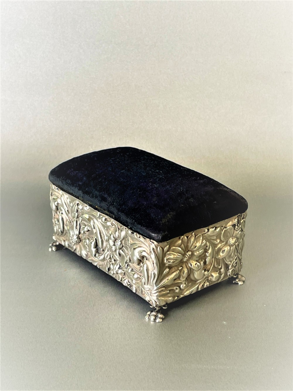 A lovely silver cased trinket box with pin cushion lid View V