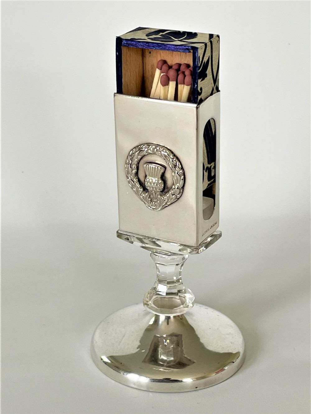An unusual hallmarked silver & glass matchbox stand