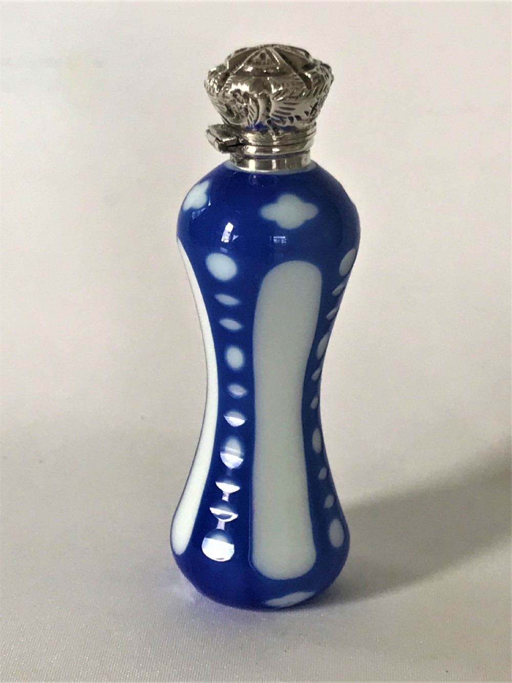 A rare Victorian silver mounted glass overlay scent bottle